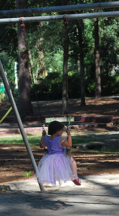 little girl swinging
