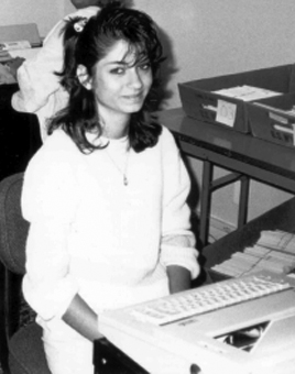 Yours truly in 1987. Working at United Way. Typing pledge cards on a typewriter. With a scrunchy in my feathered hair. 