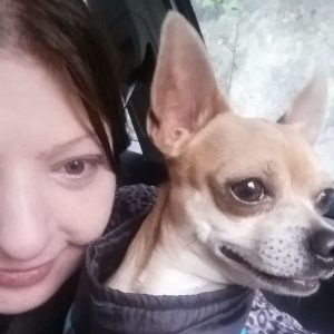 Left side of image is of half of a white-appearing woman's face. Right side is of a dog with big ears.