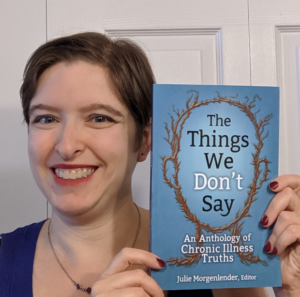 Editor Julie Morgenlender with a copy of the Anthology The Things We Don't Say: Chronic Illness Truths.