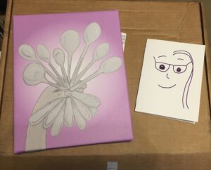 On left side, a pencil drawing of a hand holding eight spoons on a purple background. It is printed on a canvas. On the right side, an abstract line drawing of girl with long hair and wearing glasses.